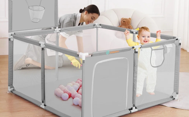 A Baby in a Portable Playpen with Basketball Hoop