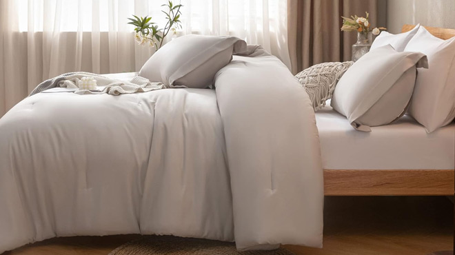 A Bed Fitted with Janzaa 7 Piece Queen Comforter Set