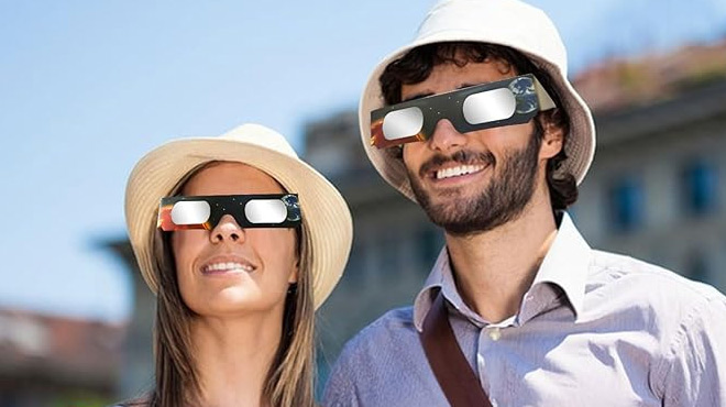 A Couple Wearing Tolivo Solar Eclipse Glasses 12 Pack