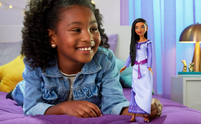 A Girl Holding a Disney Wish Asha of Rosas Posable Fashion Doll
