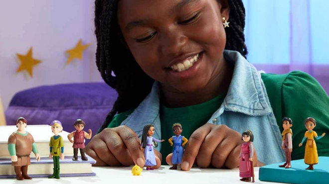 A Girl Playing With Disney Wish The Teens Mini Dolls 8 Piece Set