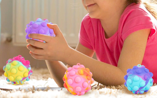 A Girl Playing with Pop Fidget Ball Toys