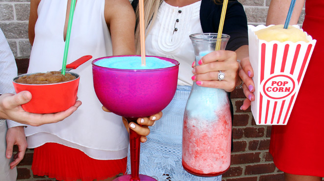 A Group of People Holding Large Cups Filled with 7 Eleven Slurpees A Group of People Holding Large Cups Filled with 7 Eleven Slurpees