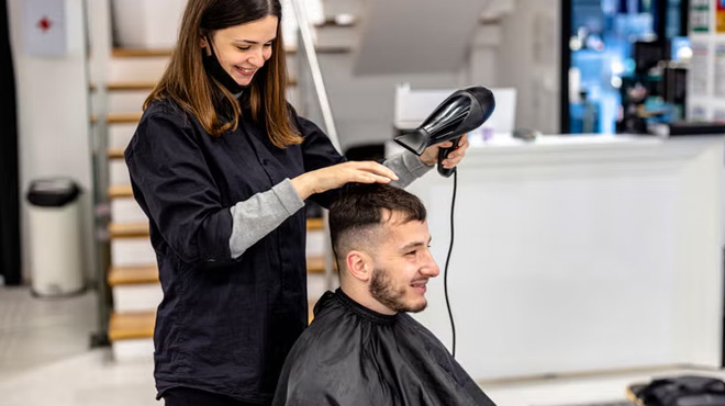 A Hairstylist Blow Drying a Mens Hair