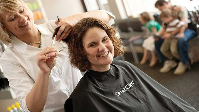 A Hairstylist Clipping Hair of a Woman