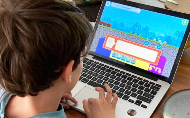 A Kid Playing CodeSpark Games on a Laptop