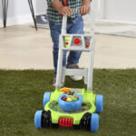 A Kid with a VTech Pop and Spin Mower Toy
