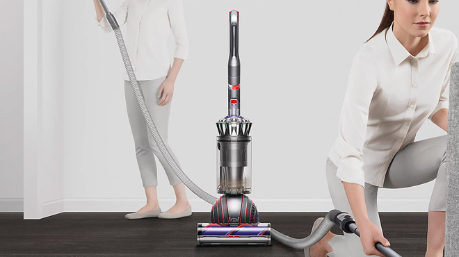 A Lady Cleaning a Living Room Using a Dyson Ball Animal 3 Upright Vacuum