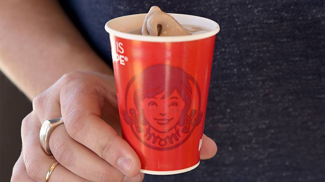 A Man Holding a Small Frosty from Wendy's
