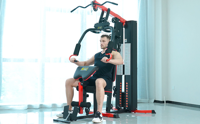 A Man Working Out Using Fitvids Home Gym System Workout Station