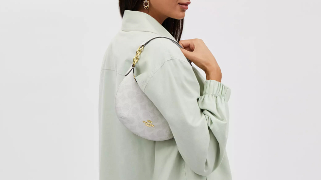 A Person Carrying a Coach Outlet Mini Payton In Signature Canvas