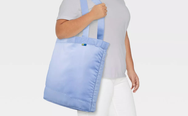 A Person Carrying an Open Story Packable Tote Bag