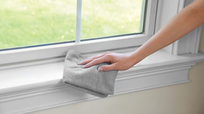 A Person Cleaning a Window Using a Rubbermaid 24 Pack Microfiber Cloth A Person Cleaning a Window Using a Rubbermaid 24 Pack Microfiber Cloth