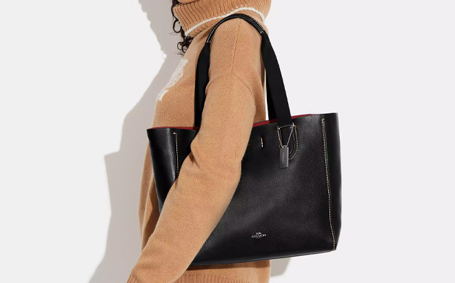 A Person Holding Coach Derby Tote Bag