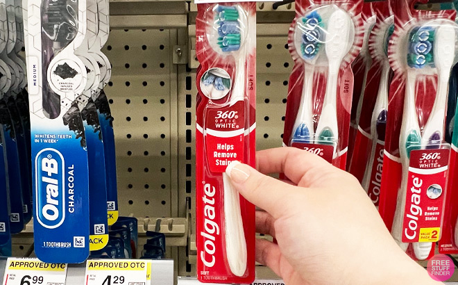 A Person Holding Colgate Manual Toothbrush at Walgreens