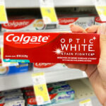 A Person Holding Colgate Optic White Toothpaste at Walgreens