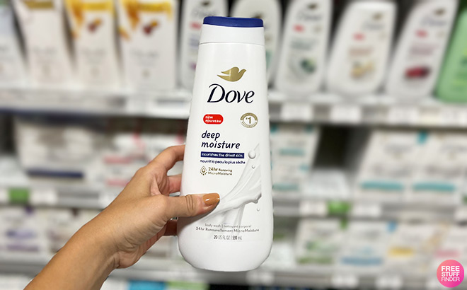 A Person Holding Dove Deep Moisture Body Wash in a Store Aisle