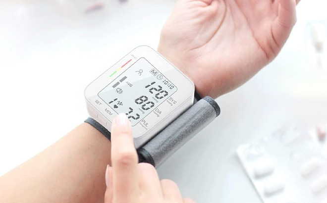 A Person Holding Wrist Blood Pressure Monitor