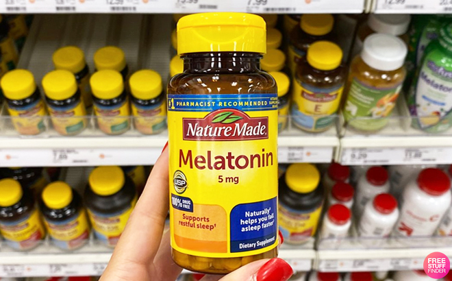 A Person Holding a Bottle of Nature Made Melatonin Tablets