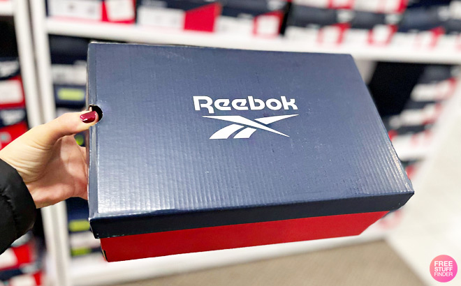 A Person Holding a Box of Reebok A Person Holding a Box of Reebok