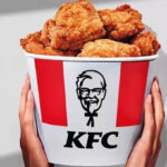 A Person Holding a Bucket of KFC Friend Chicken