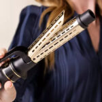A Person Holding a Hot Tools Pro Artist One Step Detachable Dryer Curler