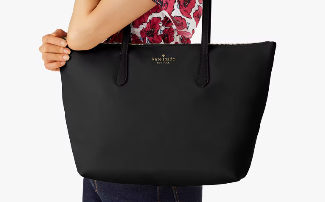 A Person Holding a Kate Spade Kitt Nylon Large Tote in Black