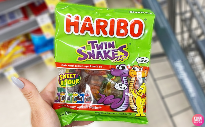 A Person Holding a Pack of Haribo Twin Snakes Gummies
