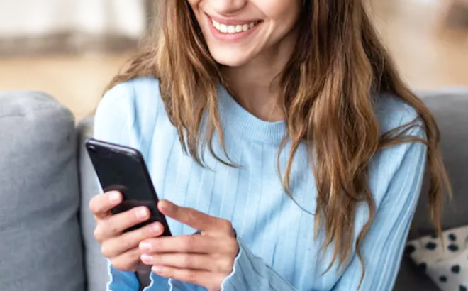 A Person Holding a Phone and Smiling