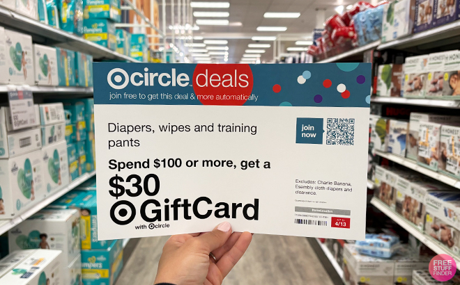 A Person Holding the Circle Deals Gift Card Sign for Diapers Wipes and Training Pants at Target