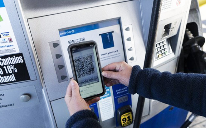 A Person Paying for Gas at a Gas Station with a Phone