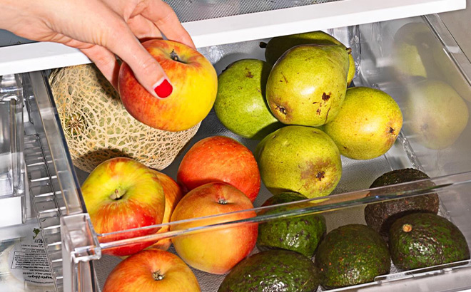A Person Taking an Apple out of a Fridge