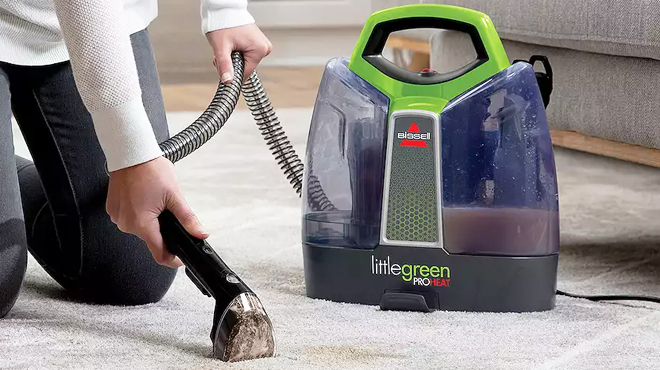 A Person Using BISSELL Little Green ProHeat Carpet Cleaner