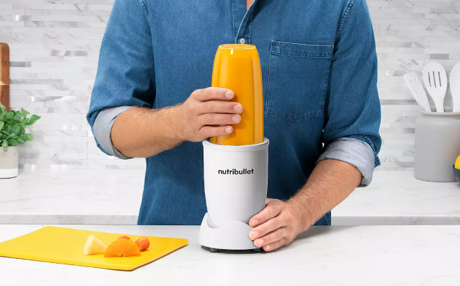 A Person Using NutriBullet Pro Nutrient Extractor Blender