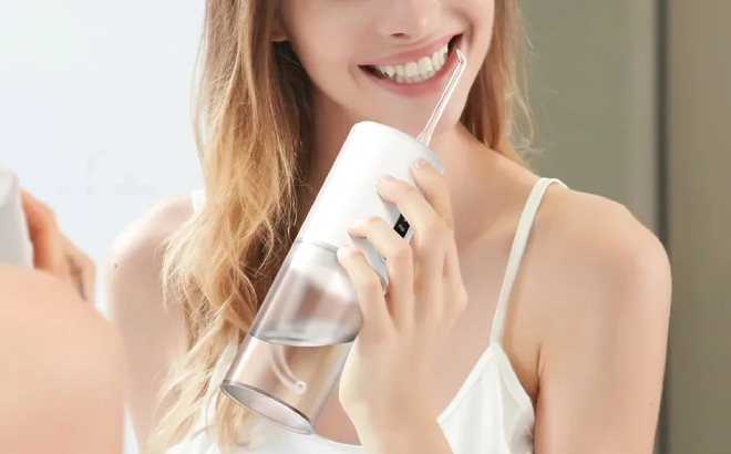 A Person Using Tinana Portable Cordless Water Dental Flosser