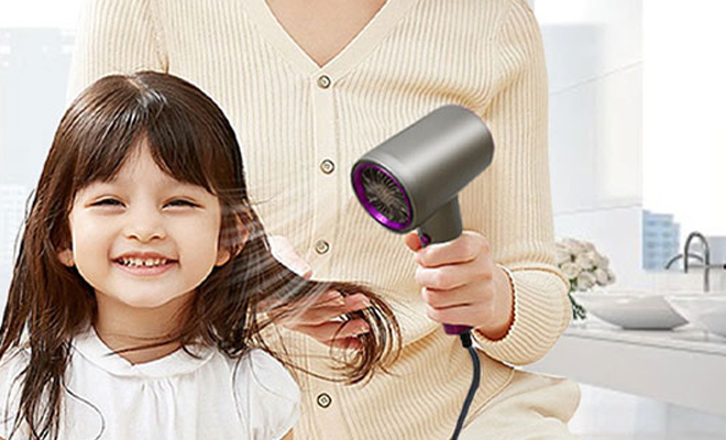 A Person Using the Professional Ionic Hair Dryer on a Childs Hair A Person Using the Professional Ionic Hair Dryer on a Childs Hair