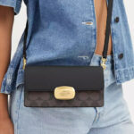 A Person Wearing Coach Outlet Eliza Small Flap Crossbody In Signature Canvas