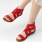 A Person Wearing Dream Pairs Womens Elastic Ankle Strap Sandals in Red Color