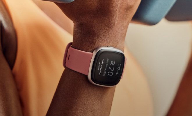 A Person Wearing the Fitbit Versa 4 Fitness Smartwatch While Working Out