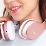 A Person With Zihnic Foldable Bluetooth Headphones in Rose Gold Color
