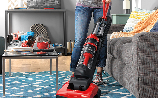 A Woman Cleaning with the Dirt Devil Power Express Upright Bagless Vacuum