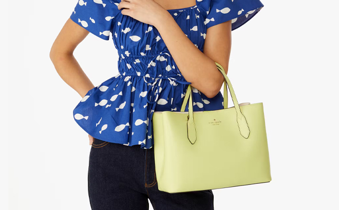 A Woman Holding Kate Spade Harper Satchel in Bosc Pear