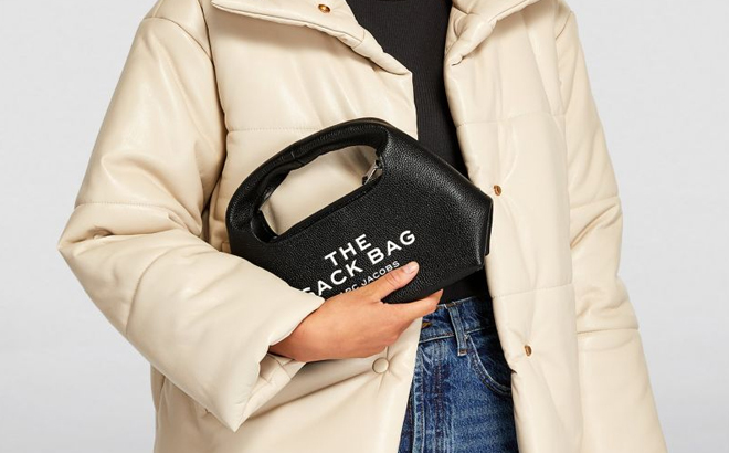 A Woman Holding Marc Jacobs The Mini Sack Bag in Black