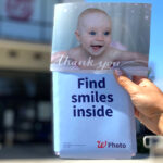 A Woman Holding a 5×7 Photo Card from Walgreens Photo
