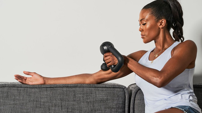 A Woman Using a Theragun Prime Massage Gun A Woman Using a Theragun Prime Massage Gun
