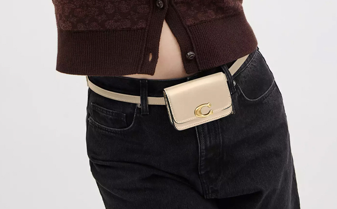 A Woman Wearing Coach Outlet Bandit Card Case Belt Bag in Beige