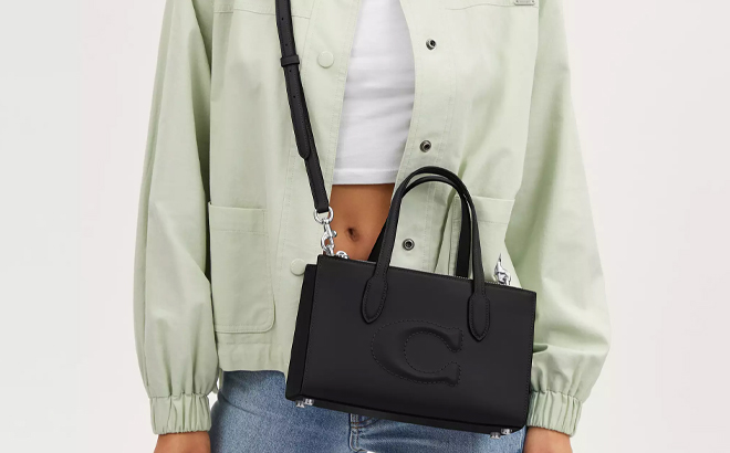 A Woman Wearing Coach Outlet Nina Small Tote Bag