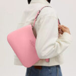 A Woman Wearing Coach Outlet Penelope Shoulder Bag in Flower Pink
