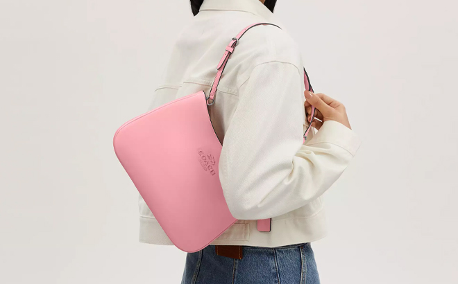 A Woman Wearing Coach Outlet Penelope Shoulder Bag in Flower Pink