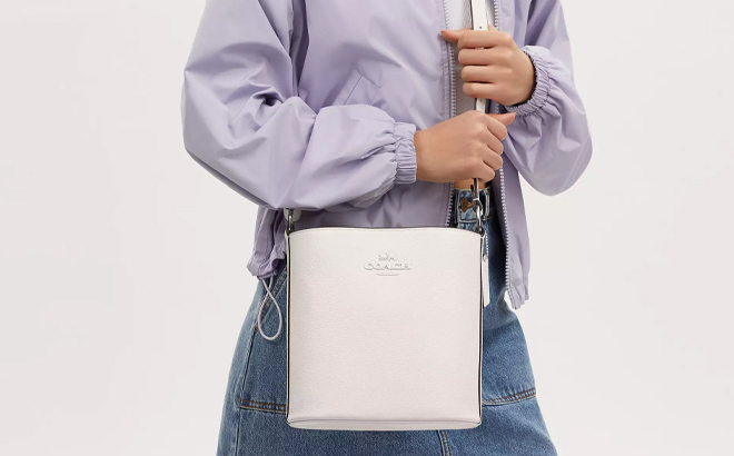 A Woman Wearing Coach Outlet Sophie Bucket Bag